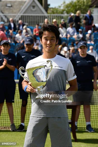 Yuichi Sugita of Japan with the trophy after victory in the final match against Jordan Thompson of Australia during the Aegon Surbiton Trophy tennis...