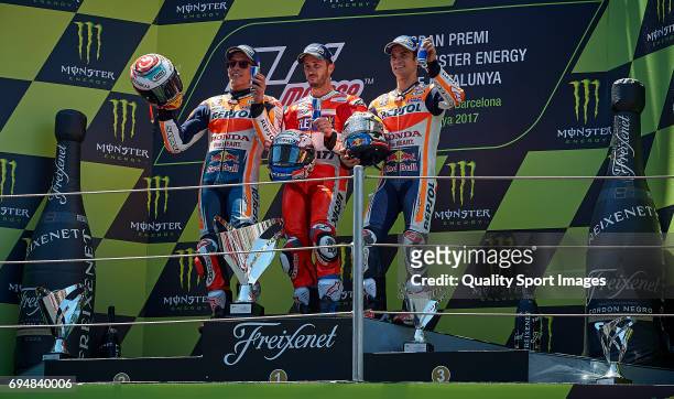 Andrea Andrea Dovizioso of Italy and Ducati Team celebrates on the podium next to Marc Marquez of Spain and Repsol Honda Team second and Dani Pedrosa...