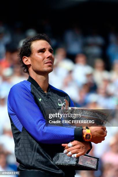 Spain's Rafael Nadal poses with his trophy after winning the men's final tennis match against Switzerland's Stanislas Wawrinka at the Roland Garros...