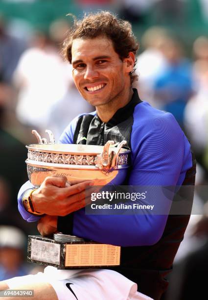 Rafael Nadal of Spain celebrates victory with the trophy following the mens singles final against Stan Wawrinka of Switzerland on day fifteen of the...