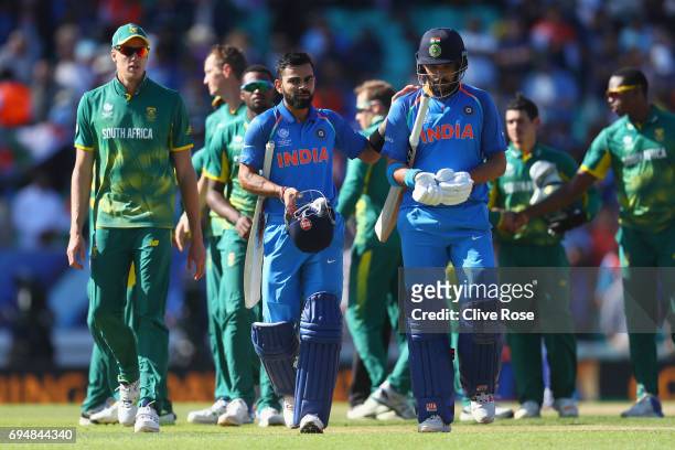 Virat Kohli and Yuvraj Singh of India in leave the field after India win the ICC Champions trophy cricket match between India and South Africa at The...