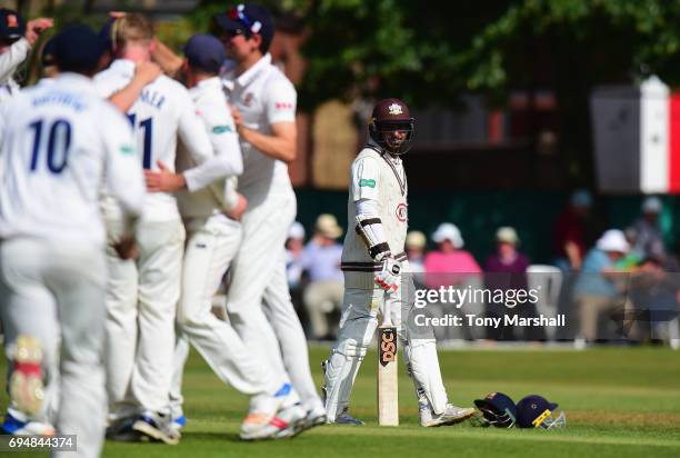 Kumar Sangakkara of Surrey walks off after being caught out during the Specsavers County Championship: Division One match between Surrey and Essex at...