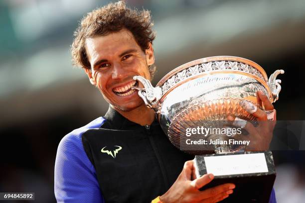 Rafael Nadal of Spain celebrates victory with the trophy following the mens singles final against Stan Wawrinka of Switzerland on day fifteen of the...