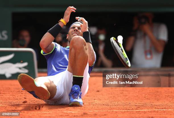 Rafael Nadal of Spain falls backwards after victory during his match against Stan Wawrinka of Switzerland during the Men's Singles Final, on day...