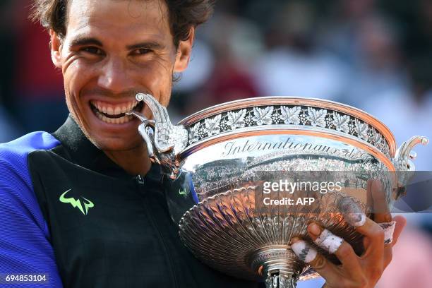 Spain's Rafael Nadal poses with the trophy after the men's final tennis match against Switzerland's Stanislas Wawrinka at the Roland Garros 2017...