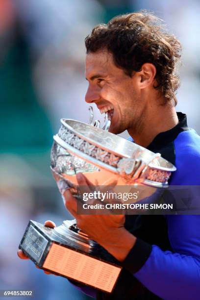 Spain's Rafael Nadal poses with the trophy after winning the men's final tennis match against Switzerland's Stanislas Wawrinka at the Roland Garros...