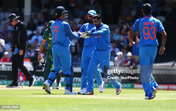 Ravinda Jadeja of India celebrate the wicket of Quinton de Kock of South Africe withMS Dhoni of India during the ICC Champions Trophy match Group B...