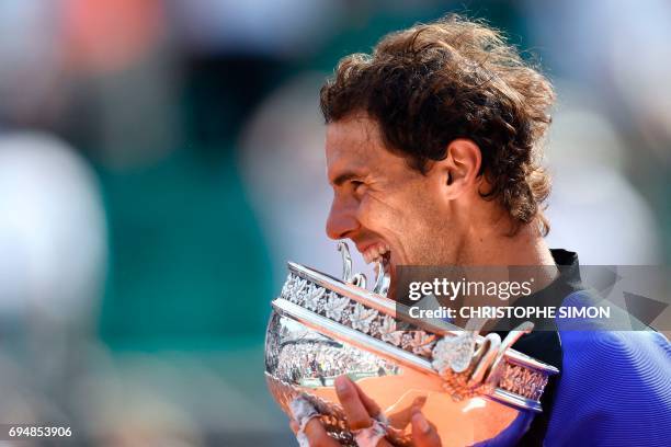 Spain's Rafael Nadal poses with the trophy after winning the men's final tennis match against Switzerland's Stanislas Wawrinka at the Roland Garros...