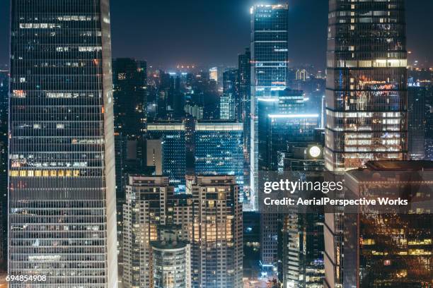 illuminated skyscrapers - urban sprawl stock pictures, royalty-free photos & images