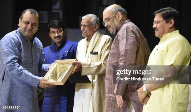 National President Amit Shah with BJP National Vice President Shyam Jaju, East Delhi MP Mahesh Girri, Delhi BJP President Manoj Tiwari Presents a...