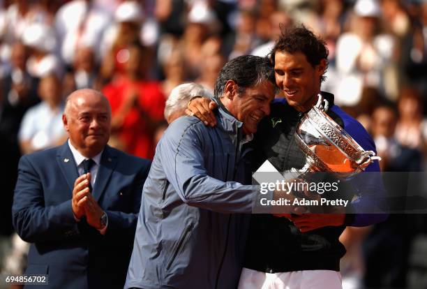 Rafael Nadal of Spain and his coach, Toni Nadal celebrate with the trophy following the mens singles final against Stan Wawrinka of Switzerland on...