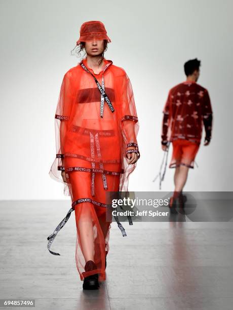 Model walks the runway at the Christopher Raeburn show during the London Fashion Week Men's June 2017 collections on June 11, 2017 in London, England.