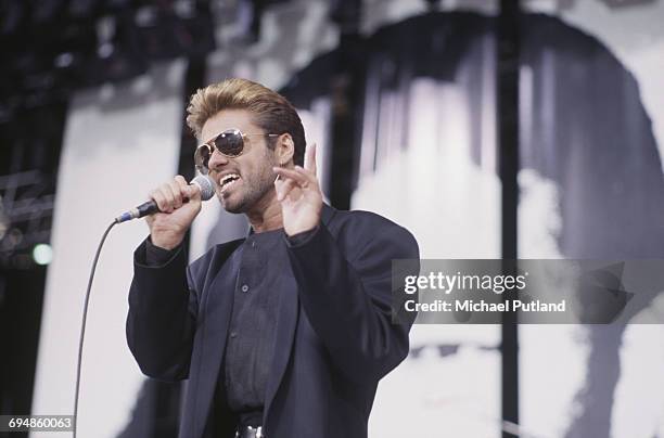 English singer, songwriter and musician, George Michael performs live on stage at the Nelson Mandela 70th Birthday Tribute concert at Wembley Stadium...