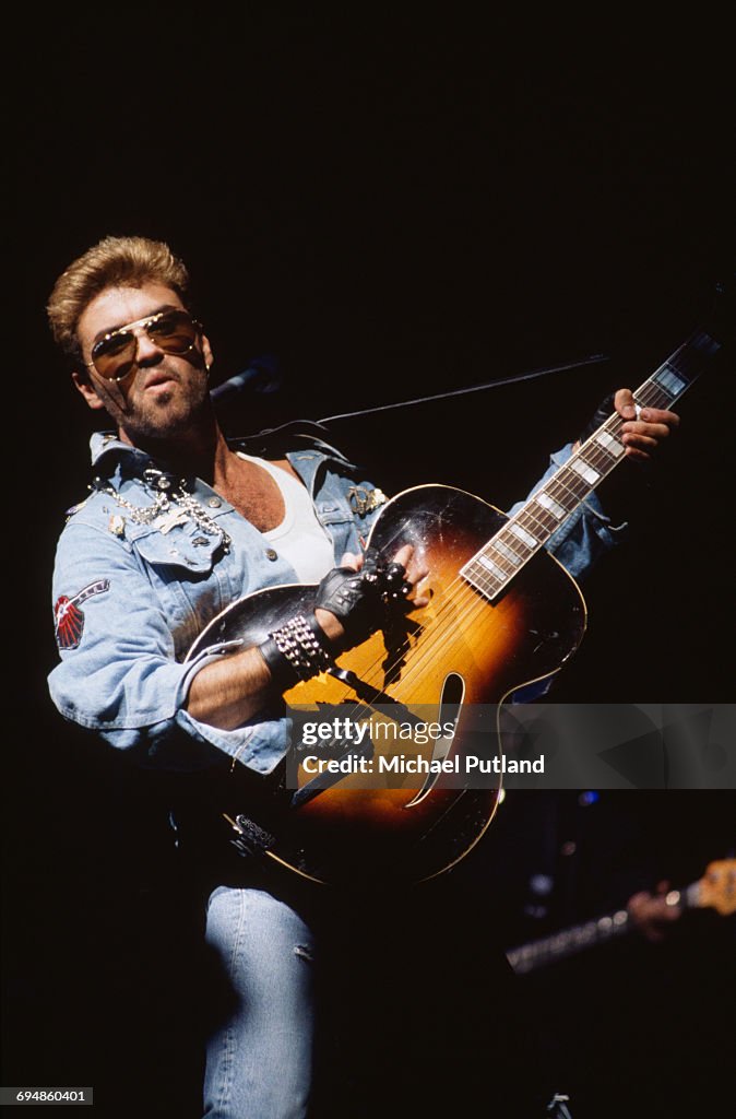 George Michael Instruments English singer and songwriter George Michael performing on stage ...