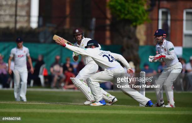 Ben Foakes of Surrey hits his shot past Dan Lawrence of Essex during the Specsavers County Championship: Division One match between Surrey and Essex...