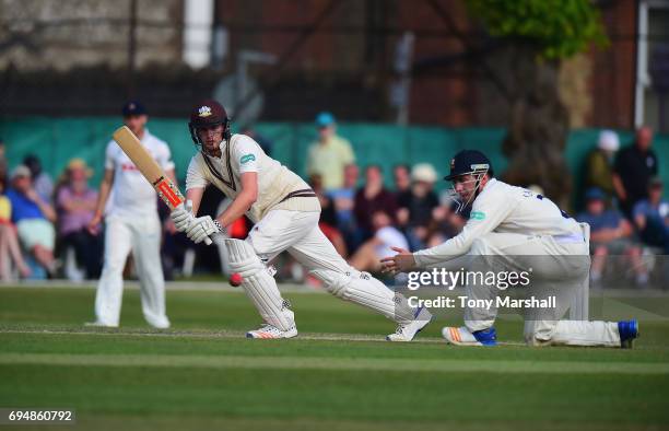 Dominic Sibley of Surrey hits his shot past Dan Lawrence of Essex during the Specsavers County Championship: Division One match between Surrey and...