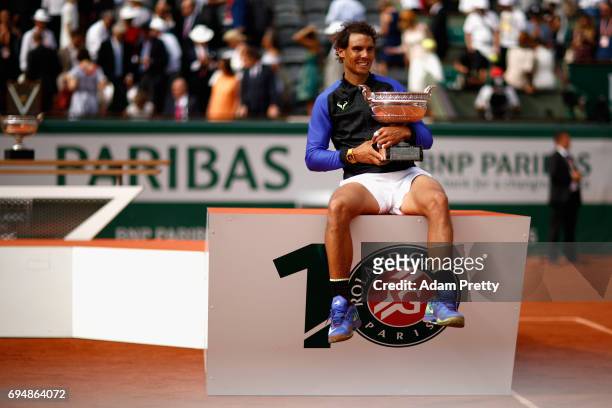 Rafael Nadal of Spain celebrates victory with the trophy following the mens singles final against Stan Wawrinka of Switzerland on day fifteen of the...