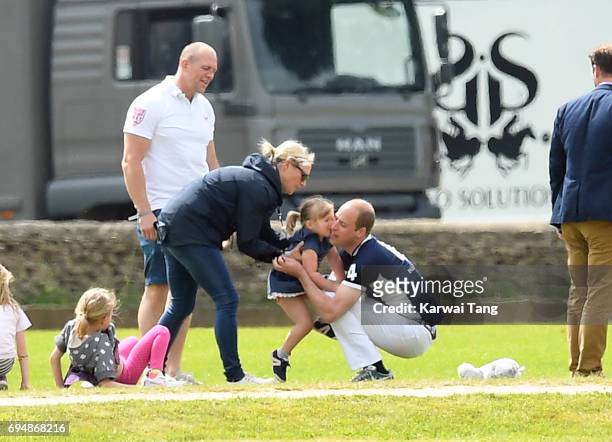 Mike and Zara Tindall watches daughter Mia get a hug from Prince William, Duke of Cambridge at the Maserati Royal Charity Polo Trophy at Beaufort...