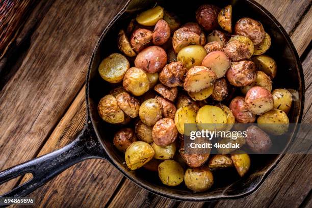 pan fried yukon gold potatoes with herb in cast iron - fried potato stock pictures, royalty-free photos & images