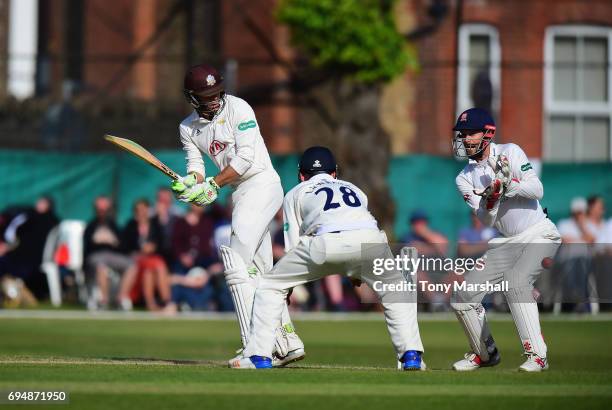 Ben Foakes of Surrey hits his shot past James Foster of Essex during the Specsavers County Championship: Division One match between Surrey and Essex...