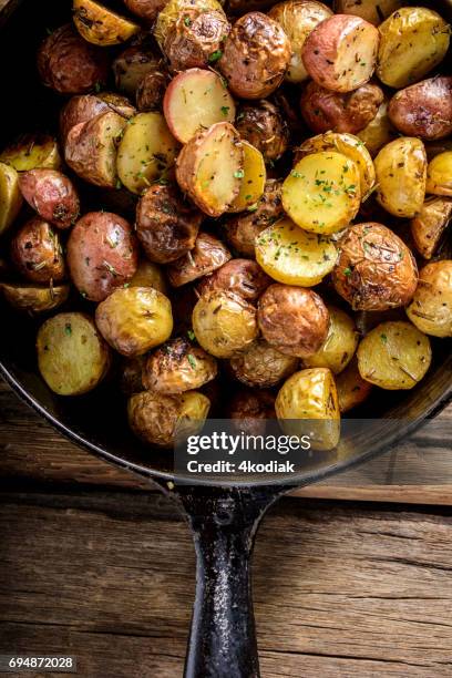 pan fried yukon gold potatoes with herb in cast iron - yukon gold stock pictures, royalty-free photos & images