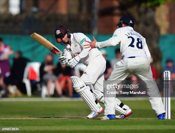 Gareth Batty of Surrey hits his shot past Dan Lawrence of Essex during the Specsavers County Championship: Division One match between Surrey and...
