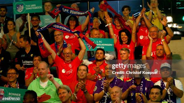 Club members of 1. FC Rielasingen-Arlen celebrate after being chosen Borussia Dortmund in the first round during the DFB Cup Draw at Deutsches...