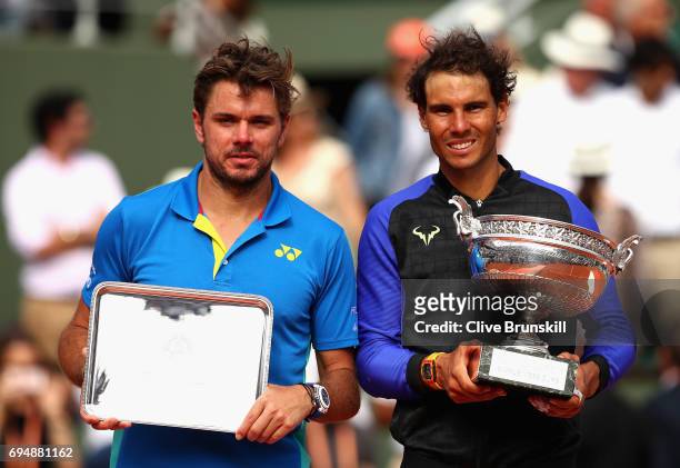 Winner, Rafael Nadal of Spain and Runner Up Stan Wawrinka of Switzerland pose with their trophies following the mens singles final on day fifteen of...