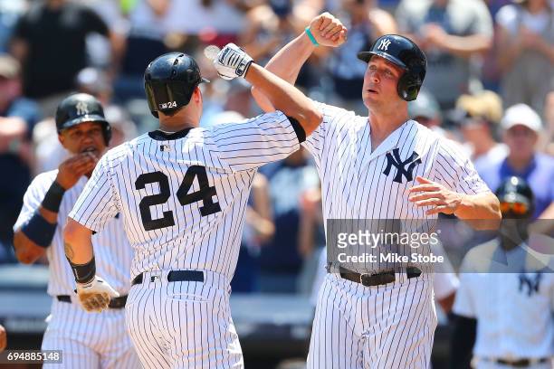 Gary Sanchez of the New York Yankees is greeted by Matt Holliday after connecting on a 3-run home run in the first inning against the Baltimore...