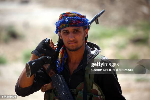 Member of the Syrian Democratic Forces , made up of an alliance of Kurdish and Arab fighters, walks after they entered the western front of the...