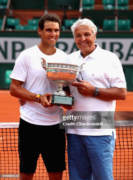 Rafael Nadal of Spain and his Dad, Sebastian Nadal, hold the winners trophy following the mens singals final match between Stan Wawrinka of...