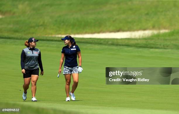 Ariya Jutanugarn of Thailand and In Gee Chun of Korea walk up the 1st fairway during the final round of the Manulife LPGA Classic at Whistle Bear...