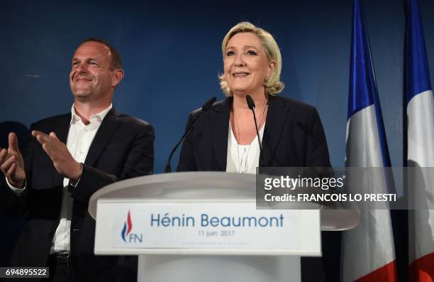 France's far-right National Front leader and parliamentary candidate Marine Le Pen gives a speech next to Henin-Beaumont Mayor Steeve Briois after...