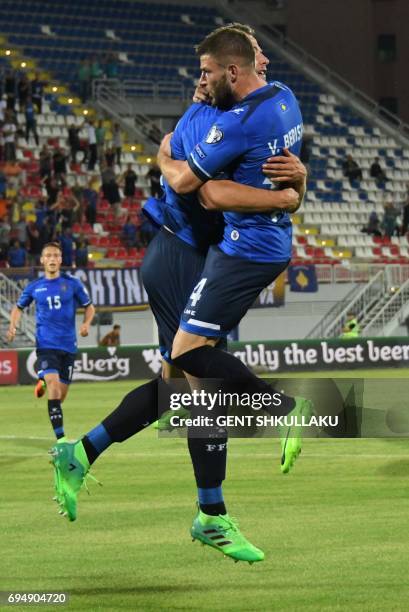 Kosovo's Amir Rrahmani celebrates with teammate Valon Berisha after scoring during the FIFA World Cup 2018 qualification football match between...