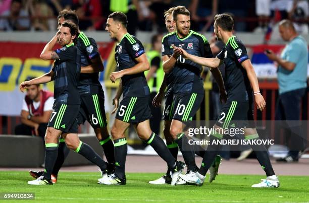 Wales' midfielder Aaron Ramsey and Wales' defender Chris Gunter celebrate after Ramsey converted a penalty during the WC 2018 football qualification...