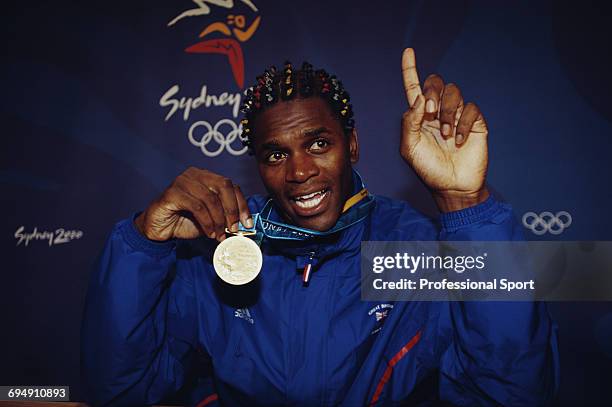 British boxer Audley Harrison proudly displays his gold medal after winning the final of the Men's Super heavyweight boxing event against Mukhtarkhan...