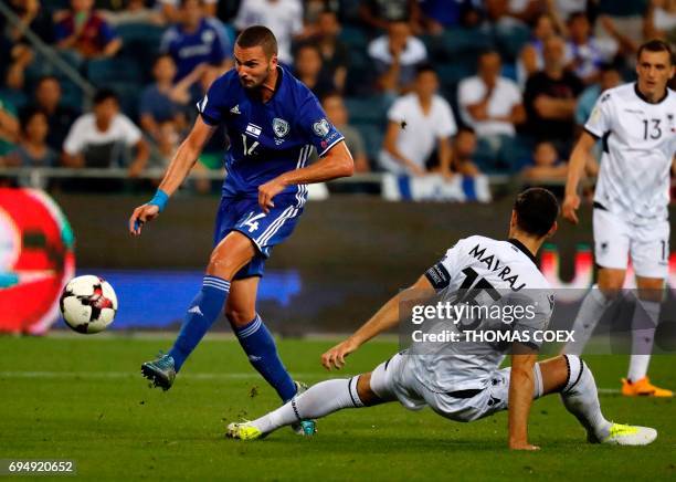 Israeli forward Ben Sahar dribbles past Albanian defender Mergim Mavraj during the FIFA World Cup 2018 qualification football match between Israel...
