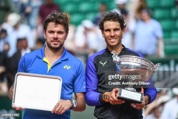 Stan Wawrinka of Switzerland and Rafael Nadal of Spain poses with their trophies during the day 15 of the French Open at Roland Garros on June 11,...