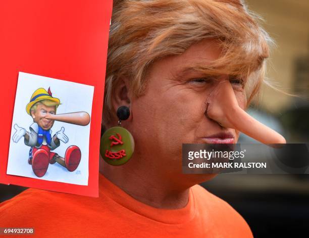 Protester dressed as the President Donald Trump waits for the start of the #ResistMarch during the 47th annual LA Pride Festival in Hollywood,...