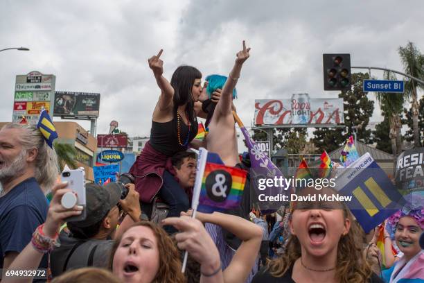 Women kiss in defiance of hateful speech from provocative street preachers at the #ResistMarch during the 47th annual LA Pride Festival on June 11 in...