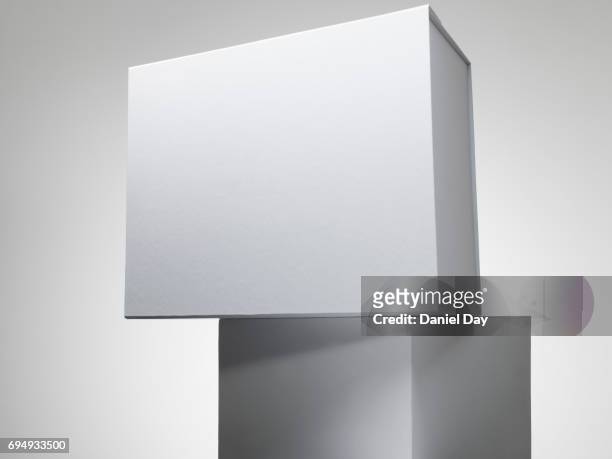 white box on a white plinth - pile of gifts stock pictures, royalty-free photos & images