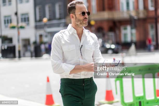 Guest wearing green pants, white button shirt during the London Fashion Week Men's June 2017 collections on June 11, 2017 in London, England.