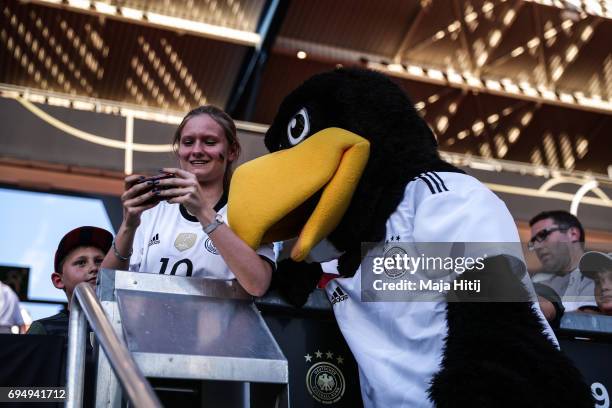 Mascot Paule poses with a fan prior to the FIFA 2018 World Cup Qualifier between Germany and San Marino on June 10, 2017 in Nuremberg, Bavaria.