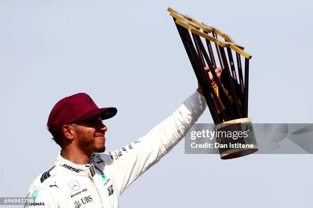 Lewis Hamilton of Great Britain and Mercedes GP celebrates on the podium after winning the Canadian Formula One Grand Prix at Circuit Gilles...