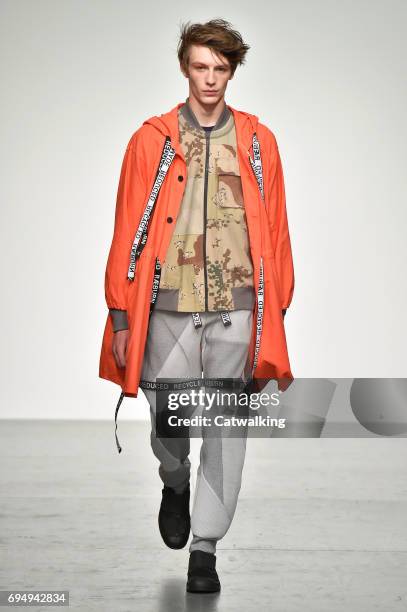 Model walks the runway at the Christopher Raeburn Show Spring Summer 2018 fashion show during London Menswear Fashion Week on June 11, 2017 in...
