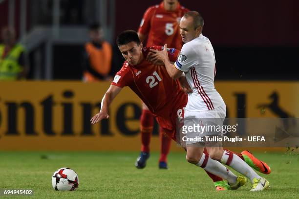 Eljif Elmas of FYR Macedonia and Andres Iniesta of Spain compete for the ball during the FIFA 2018 World Cup Qualifier between FYR Macedonia and...