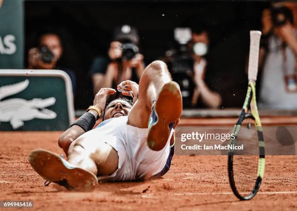 Rafael Nadal of Spain falls backwards after victory during his match against Stan Wawrinka of Switzerland during the Men's Singles Final, on day...