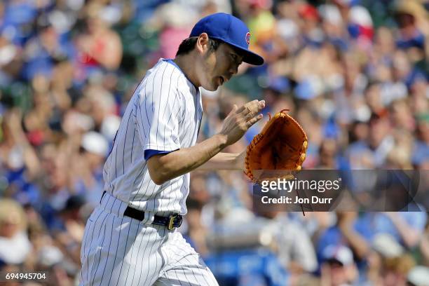 Koji Uehara of the Chicago Cubs reacts at the end of the eighth inning against the Colorado Rockies at Wrigley Field on June 11, 2017 in Chicago,...