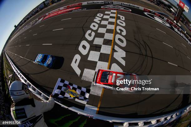 Ryan Blaney, driver of the Motorcraft/Quick Lane Tire & Auto Center Ford, takes the checkered flag to win the Monster Energy NASCAR Cup Series Axalta...