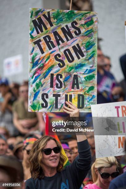 Woman holds a sign in support of her transgender son at the #ResistMarch during the 47th annual LA Pride Festival on June 11 in the Hollywood section...